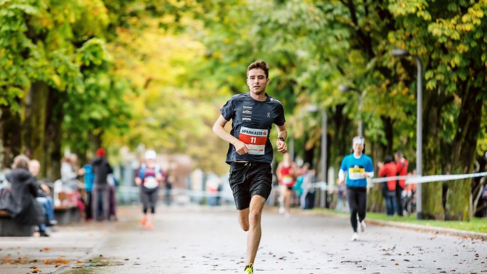 Läufer während dem 3 Länder Marathon zwischen Bäumen